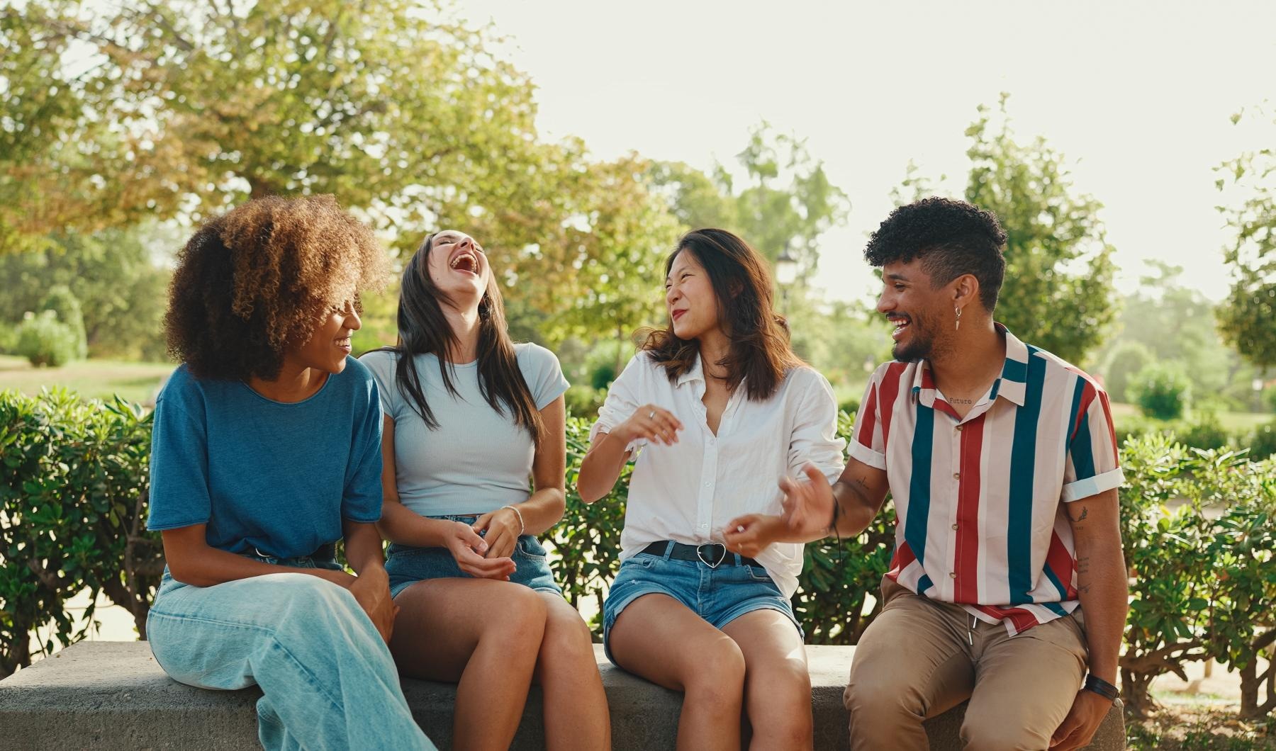 The essence of exceptional living a group of people sitting on a stone ledge