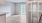 a room with a wood floor and white walls and a balcony door
