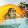Three women in the pool with round yellow float