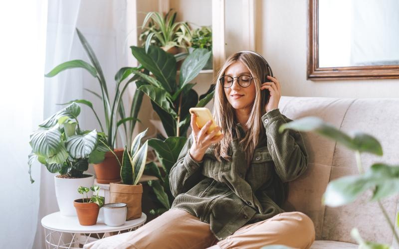 a woman sitting in a chair on her phone